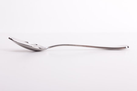Stainless steel small kitchen dessert spoon isolated over the white background, top view aboveの写真素材