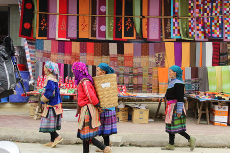 SAPA, VIETNAM - FEBRUARY 08, 2015: Hmong women at Bac Ha market in Northern Vietnam. Bac Ha is hilltribe market where people come to trade for goods in traditional costumes.のeditorial素材