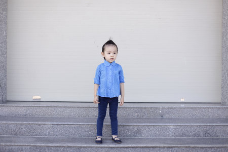 Cute lovely sweet asian chinese kid girl with smiling face on the road, jumping, running, and drink...