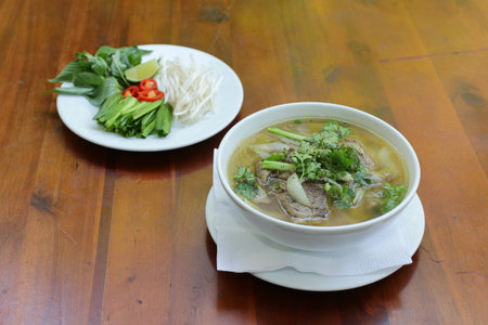 Close up of a bowl of Chinese style on wooden background ,Beef Noodle Soup.