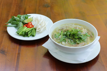 Close up of a bowl of Chinese style on wooden background ,Beef Noodle Soup.