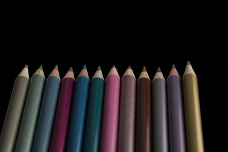 set of colour pencils isolated on black background.の写真素材