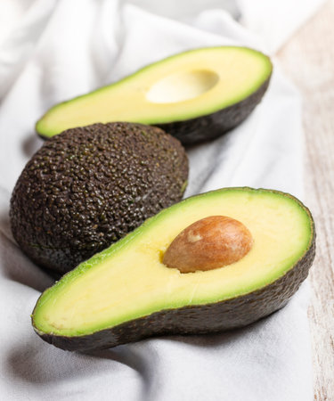 avocados on light wood and cloth backgroundの写真素材