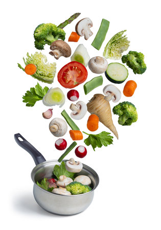 Fresh vegetables flying in a pot, isolated on white background.の写真素材