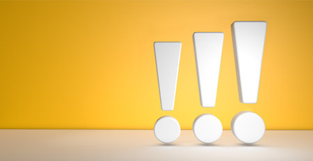 Three exclamation marks on yellow background with copy spaceの写真素材