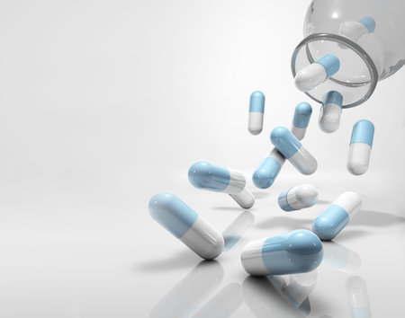 medicine capsules flying, falling out of glass container, with copy spaceの写真素材