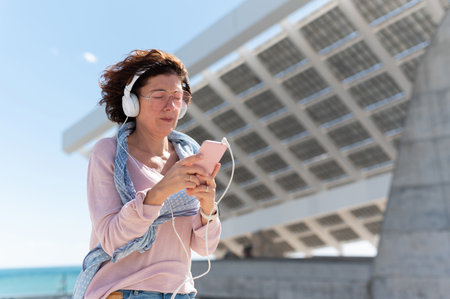 Woman with protective mask listening to music