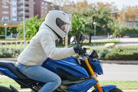 Woman driving a motorcycle through the city