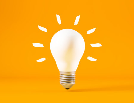 Light bulb isolated from orange background, idea conceptの写真素材