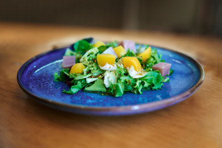 Plate of fresh salad with peach in syrupの写真素材