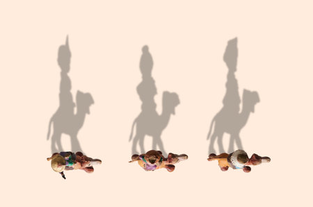 Wise men on camel high view, shadows drawing the wise men with copy spaceの写真素材