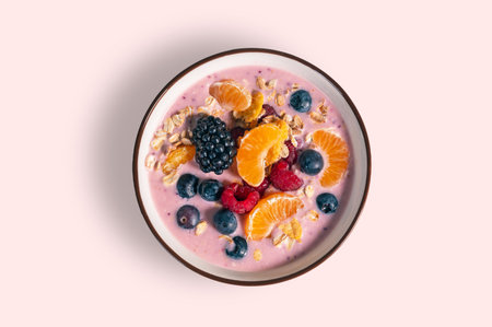 bowl of yogurt with berries and tangerine, top view isolated from the backgroundの写真素材