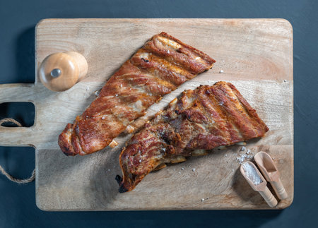 Baked Iberian pork rib on wooden background, top viewの写真素材