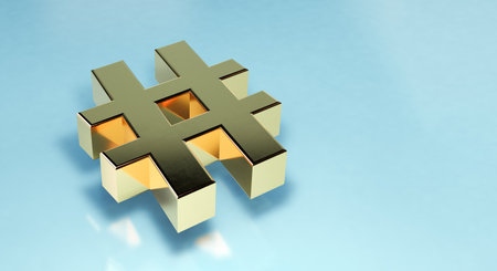 Golden hashtag sign with volume on blue background with copy spaceの写真素材