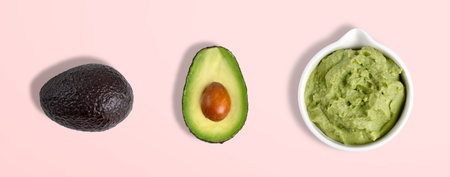 Bowl with guacamole sauce with whole and slice avocado in top view