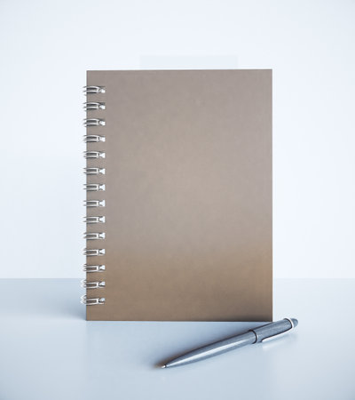 Brown notepad and pen on the table, 3d renderの写真素材