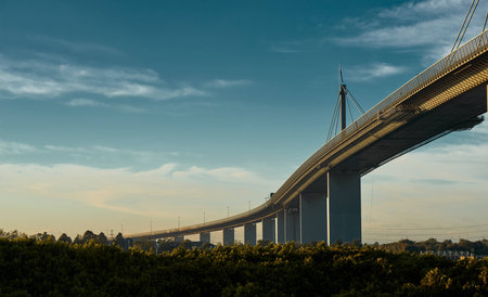 Westgate bridge in Melbourne on a beautiful, slightly cloudy morning, lit by the golden Australian...