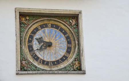 antique clock on a wall in the old townの写真素材