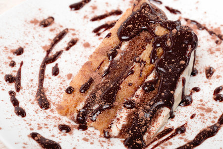 Piece of chocolate cake with icing on white  background