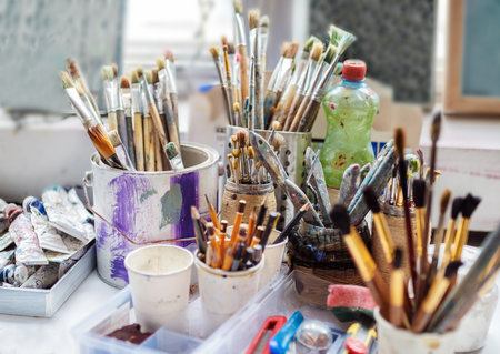 Artist paint brushes and and oil paints. Artistic concept. Artist workplace background. Art tools. Old dirty Paints background. Colorful artist palette. Soft toned. Creativity, visual art concept. Art and craft. Closeupの写真素材