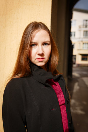 Beautiful brunette young woman posing on the street in cityの写真素材