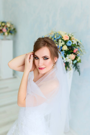 Luxury bride in white dress posing while preparing for the wedding ceremonyの写真素材