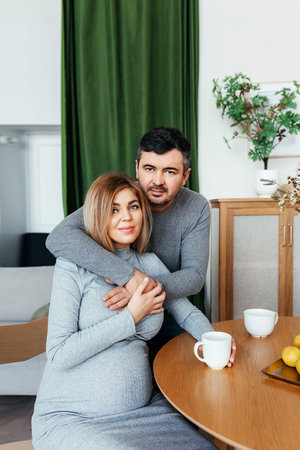 pregnant woman with her husband at homeの写真素材