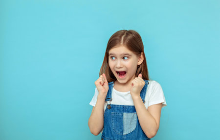 Beautiful little girl is surprised. Expressive facial expressions are the emotions of a child.の写真素材
