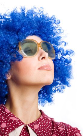 portrait of happy woman in blue wig and funny dressの写真素材