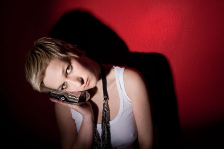 fashion woman in shiny accessories on red backgroundの写真素材