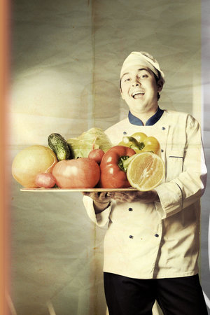 happy man with vegetables on kitchenの写真素材