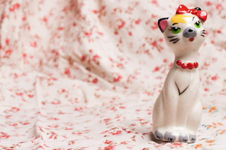 cat figurine on flower patternの写真素材