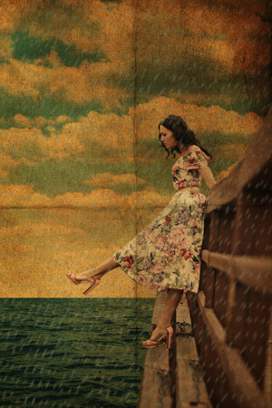 beauty youn woman on the bridge in the rainの写真素材