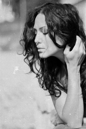 desaturated portrait of young beauty woman with curly hairsの写真素材