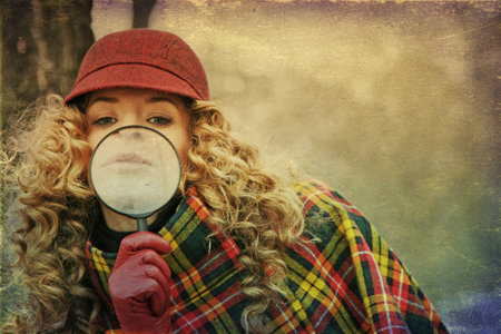 young beauty woman with magnifier glass and hat, vintageの写真素材