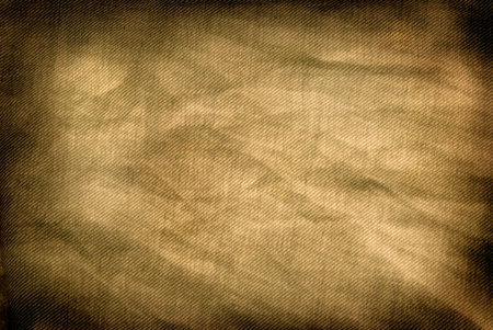 An abstract background of yellowed vintage denimの写真素材