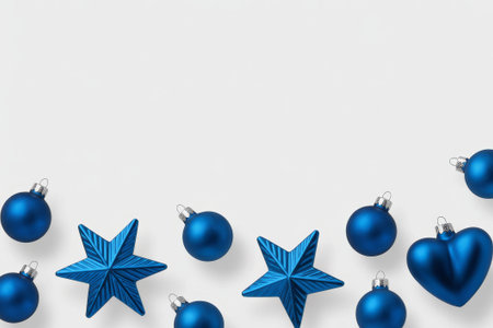 A simple Christmas greeting card design showcases blue ornaments, including stars and hearts, arranged around a festive message. This minimalist design evokes the spirit of the holiday season.の素材