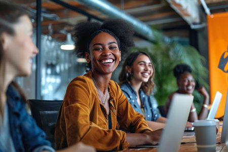 A group of professionals share a light-hearted moment, displaying camaraderie and enthusiasm while working together in a contemporary office setting with stylish interior design. Generative AI.の素材