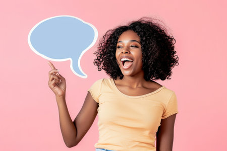 A radiant woman with a captivating smile points to a speech bubble, symbolizing cheerful communication.の素材