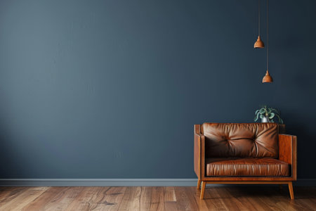 Solitary leather armchair invites relaxation against the serene backdrop of a dark blue wall, accented by soft pendant lighting.の素材