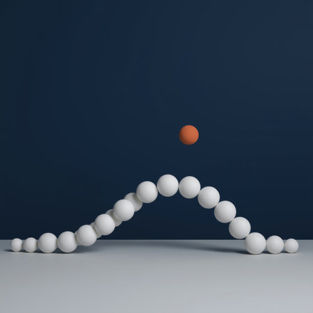 A simple arrangement of white spheres creates a smooth curve on a flat surface, with an orange sphere positioned above the peak, set against a deep blue background.の素材