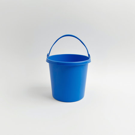 A shiny blue plastic bucket stands upright against a neutral background. Its vibrant color catches the eye, making it ideal for various tasks and activities around home or garden.の素材