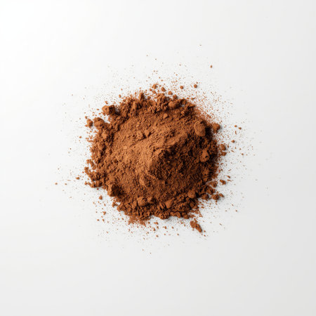 Rich, dark cocoa powder is scattered across a smooth, white surface, creating an enticing visual of its fine texture and deep color. This presentation highlights its culinary potential.の素材