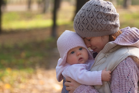 Mom hugging baby outdoorsの写真素材