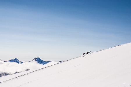 Climbing climbers on the snowy mountain top. Dream line.の写真素材
