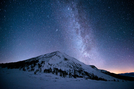 Milky Way over the snowy peaks of the Carpathian Mountainsの写真素材