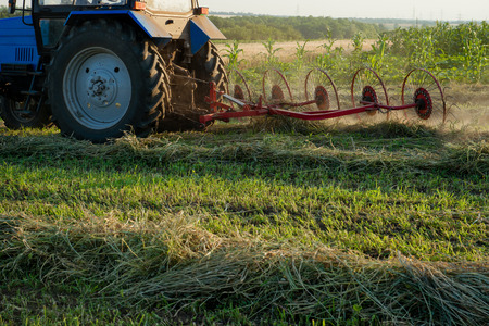 Tractor working on the farm fieldの写真素材
