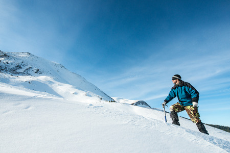 climber with an ice ax in the snowy mountainsの写真素材