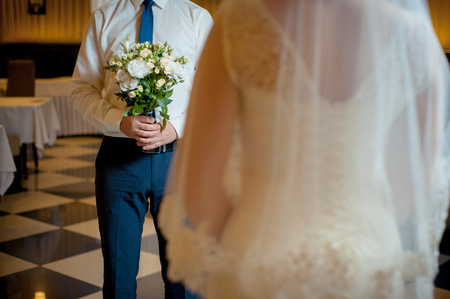 bride and groom with a bouquet of flowersの写真素材