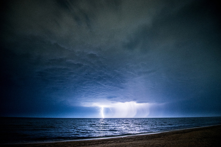Night thunderstorm with lightning above the seaの写真素材